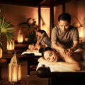body-massage-therapist-man-is-putting-massage-bed-with-woman-room-with-candle-it